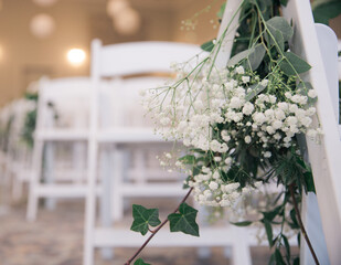 Gypsophila decoration on a white chair for a wedding ceremony