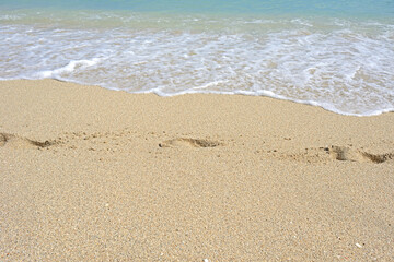 Footprints in sand near water. Miami Beach, Florida