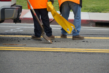 road crew fixing a pothole in the street
