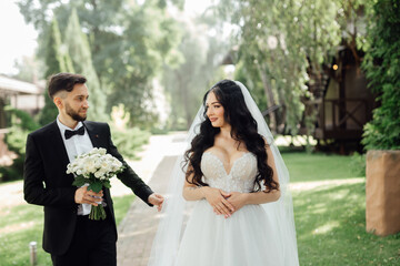 Amazing wedding couple. Beautiful bride and stylish groom.