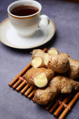 Ginger tea on wooden background.