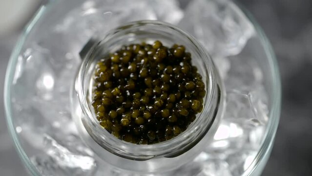  black caviar on ice with pearl spoon
