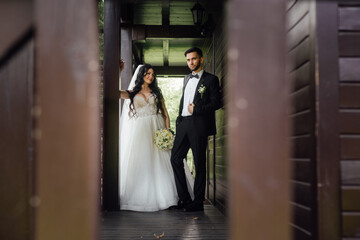 couple in love. stylish Groom in a wedding suit and the bride in a chic white dress. Wedding ceremony.