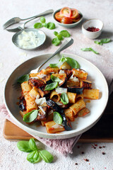 Pasta alla norma - Italian pasta with eggplant, tomato sauce and parmesan cheese. Top view.