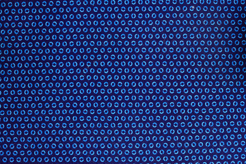 Blue fabric with small circular patterns.