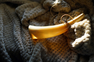 A wind instrument used in hunting. It is a tube that is made from a right corner.