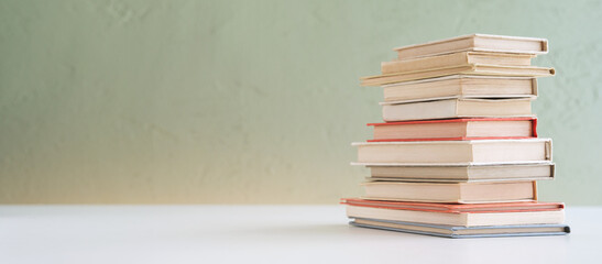 Pile of miniature vintage books.	
