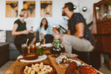 friends having relax time together with comfort food and wine