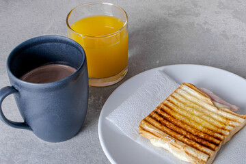 Grilled ham and cheese. Sandwich with cheese and ham on the grill.