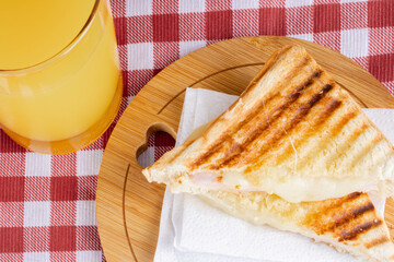 Grilled ham and cheese. Sandwich with cheese and ham on the grill.