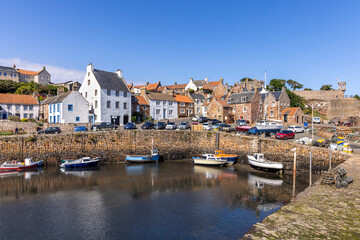 Fototapeta na wymiar The historic fishing village of Crail, with its picturesque harbour and colourful fishing boats, on the east coast of Fife, Scotland.