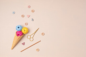 Colorful balls of organic cotton yarn waffle cones for ice cream . Recomforting hobby to reduce stress