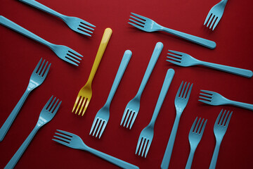 Group of blue forks on red background