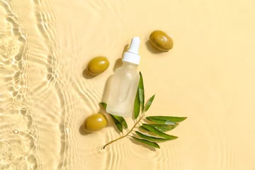 Gordijnen Bottle of essential olive oil in water on color background © Pixel-Shot