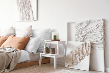 Interior of modern bedroom with stepladder and creative artwork