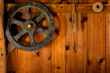 Rustic wooden wall with iron wheel