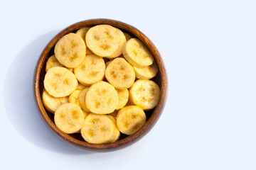 Banana slices in wooden bowl on white background