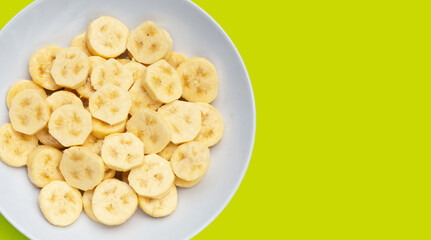 Banana slices isolated on green background