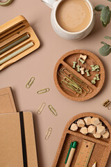 Flatlay of office supplies made of recycled materials on beige background with copy space for text. Banner, flat lay, top view