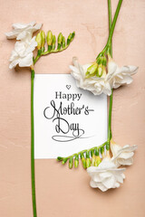 Greeting card with text HAPPY MOTHER'S DAY and beautiful freesia flowers on color background