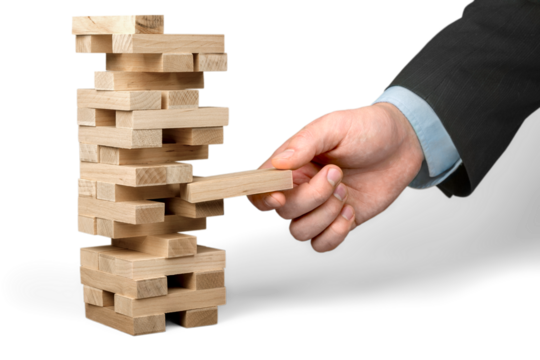 Close up of businessman and  tower of wooden blocks