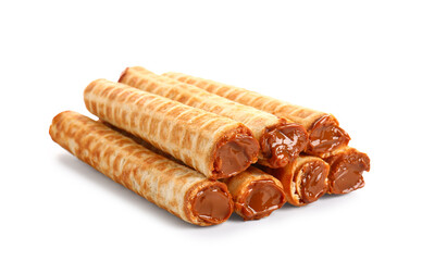 Stack of delicious wafer rolls with boiled condensed milk isolated on white background