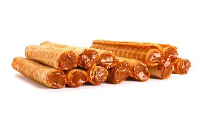 Stack of delicious wafer rolls with boiled condensed milk isolated on white background