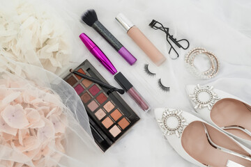 photo of Cosmetics on bright background and wedding shoes