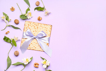 Composition with Jewish flatbread matza for Passover, walnuts and alstroemeria flowers on color background