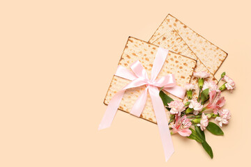 Composition with Jewish flatbread matza for Passover and flowers on color background