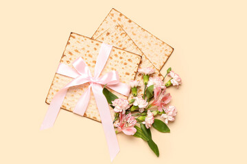 Composition with Jewish flatbread matza for Passover and flowers on color background