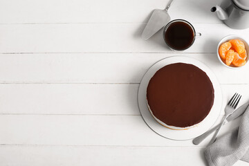 Delicious birds milk cake, cup of coffee and tangerine on light wooden background