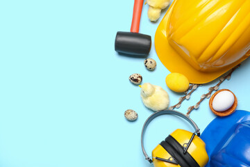 Builder's tools with chickens, Easter eggs and willow branches on blue background - obrazy, fototapety, plakaty