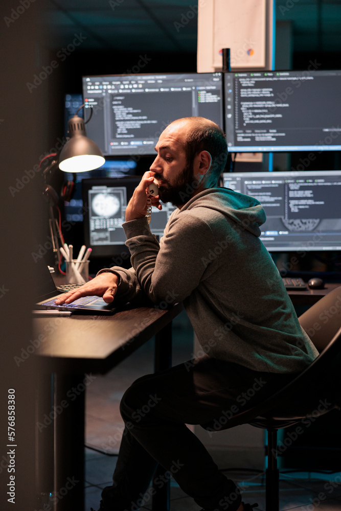 Poster it engineer answering landline phone call in office, talking about coding html script on cord teleph