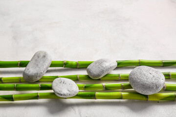 Obraz na płótnie Canvas Spa stones and bamboo on white background, top view