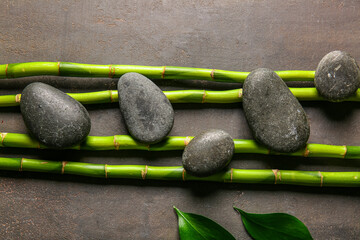 Obraz na płótnie Canvas Spa stones and bamboo on dark background, top view