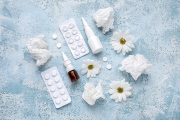 Fototapeta na wymiar Nasal drops with pills, flowers and tissues on grunge background. Seasonal allergy concept