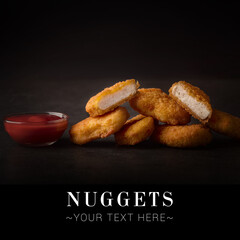 Side view of fried chicken nuggets with tomato ketchup dip sauce. Dish on black background. Ready...