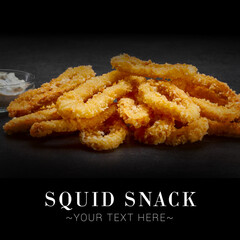 Side view of fried squid rings with creamy dip sauce. Dish on black background. Ready advertising banner with text and copy space image.