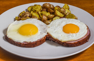 fried egg on ham  with homefries