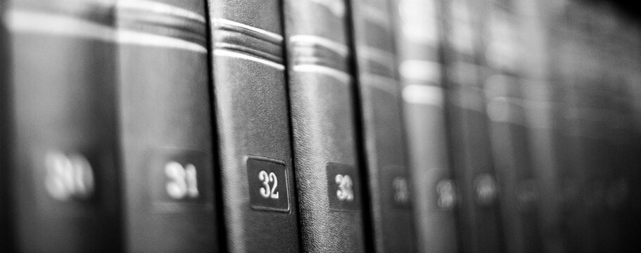 abstract financial legal lawyer business background with macro detail of office supplies and technology. defocused black and white horizontal photo