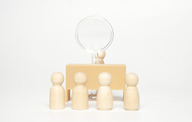 Selective focus picture of office desk with magnifying glass and peg doll at the back with blur peg dolls  insight. Talent searching concept.