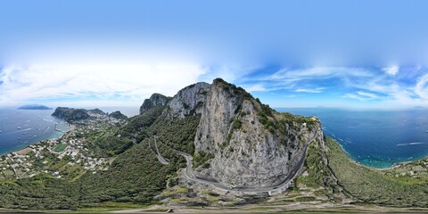 360 aerial photo taken with drone of harbor and mountain on island of Amalfi