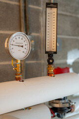 Closeup image of a hot water pressure gauge.
