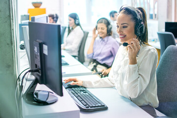 Smiling agent woman communicating with customer in order to resolve issues that client might...