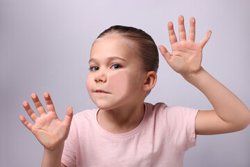 Cute little girl stuck to transparent screen