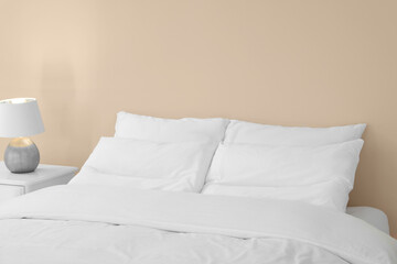 White soft pillows on cozy bed in room