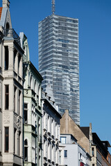 beautiful old buildings from the end of the 19th century in the belgian quarter of cologne in front of the modern skyscraper kölnturm in the background