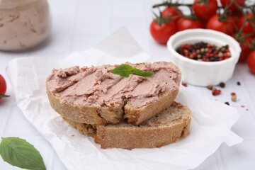 Fototapeta na wymiar Delicious liverwurst sandwich with basil on white table