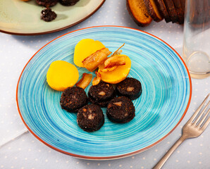Fried blood sausage with potatoes served at plate, dish of Belarussian cuisine
